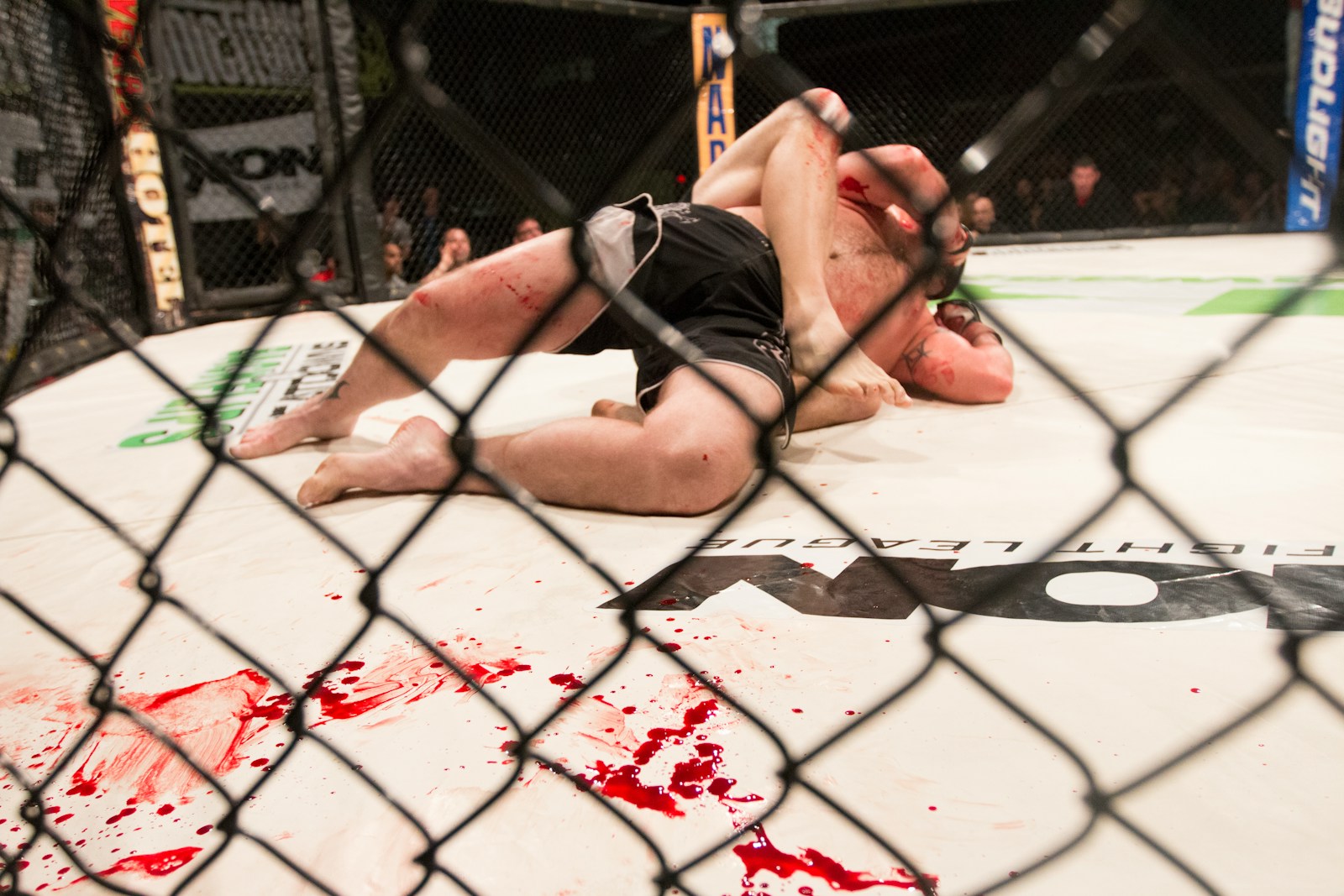 Photo by Daniel Lloyd Blunk-Fernández a man laying on top of a wrestling ring